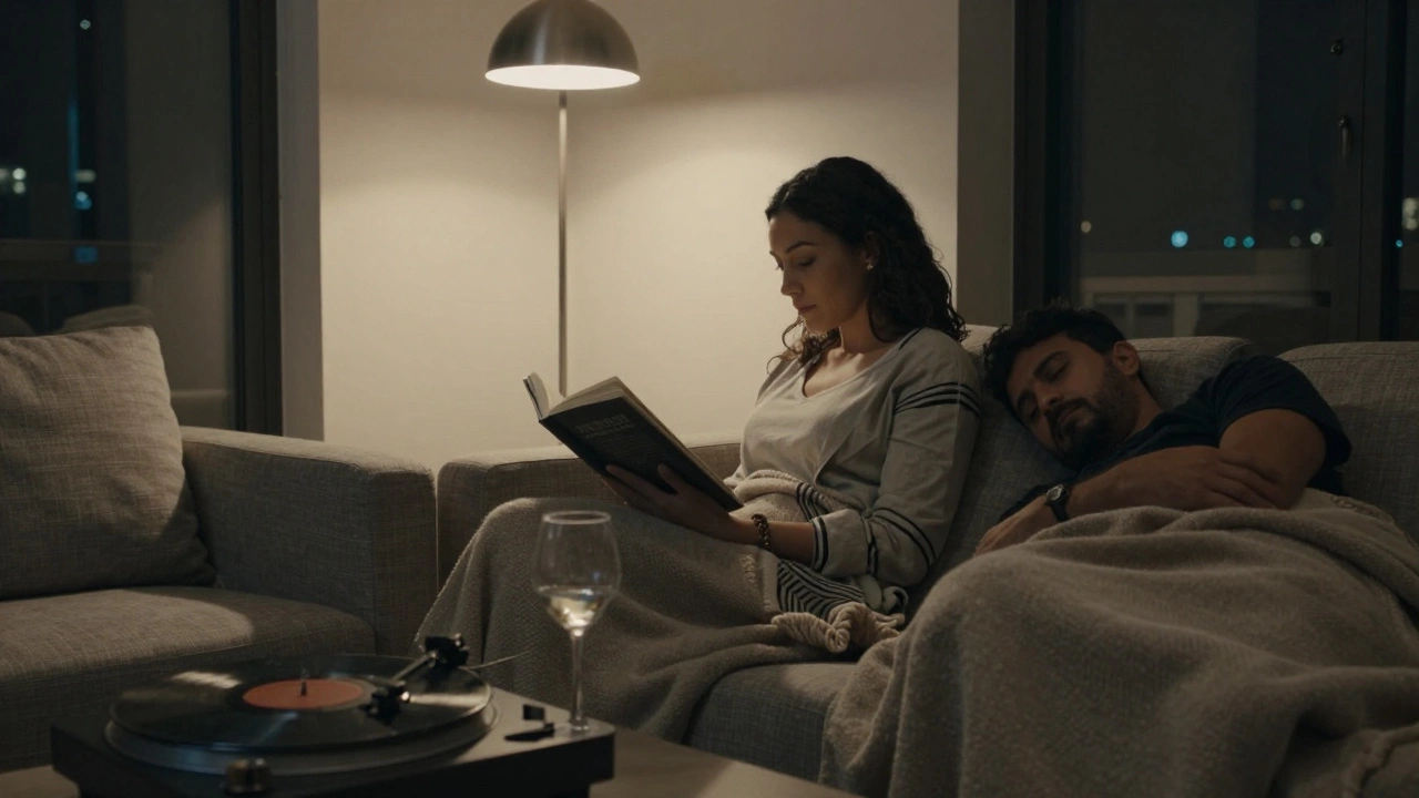 A woman reading on a sofa while a man sleeps peacefully in a softly lit Dubai apartment.